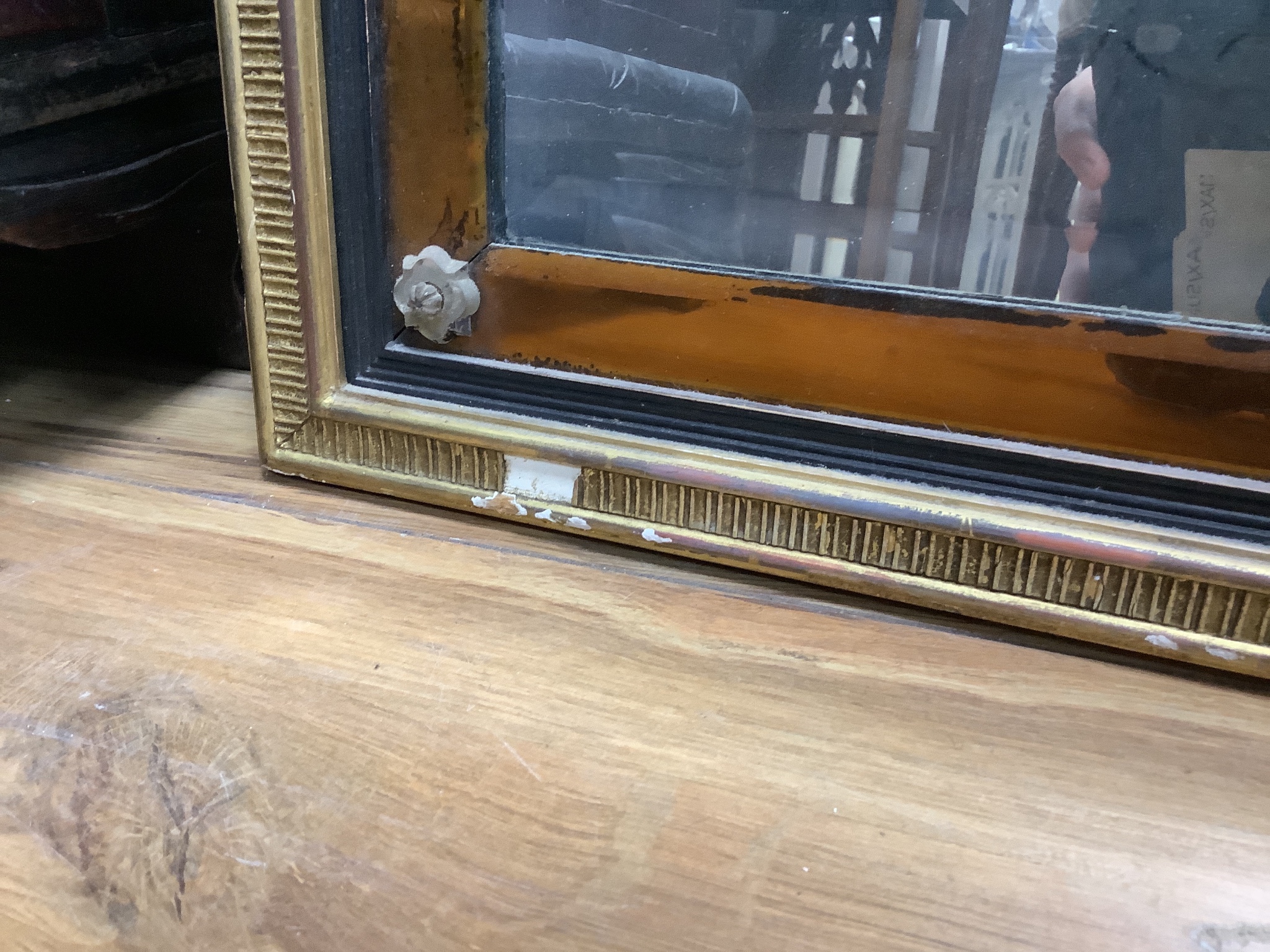 An 18th century moulded gilt overmantel, three mirror plates and amber glass borders and clear glass rosettes